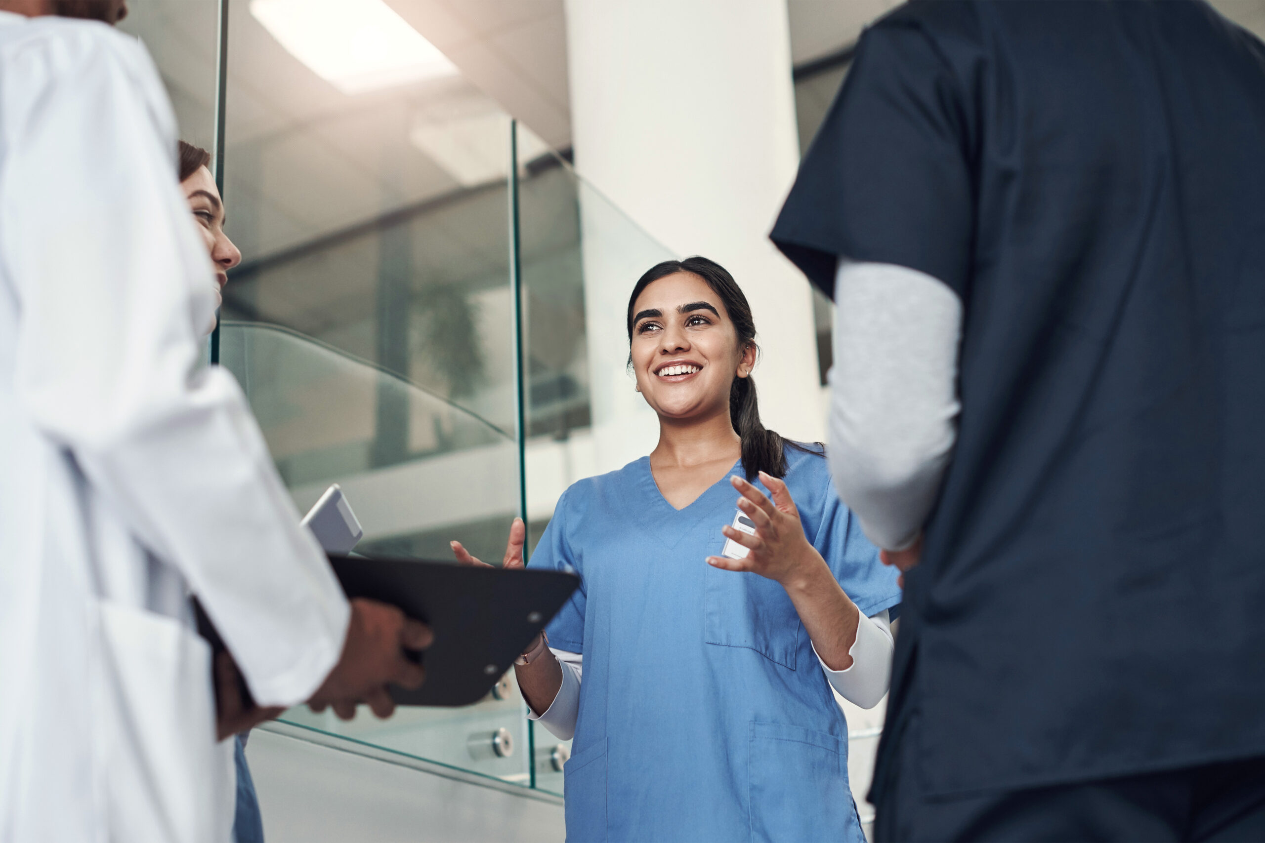 Shot Of A Young Female Nurse Having A Meeting With Doctors